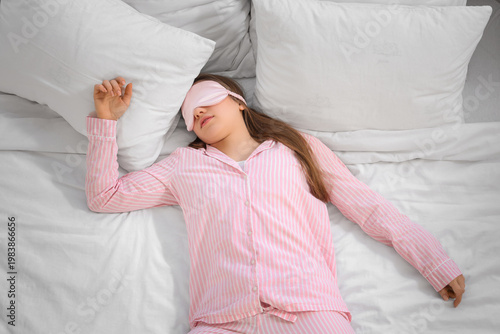 Young woman with mask sleep...