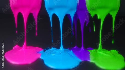 Vibrant Paint Dripping: A captivating visual of vibrant neon paint dripping from above, creating a visually stunning, colorful spectacle against a dark backdrop.