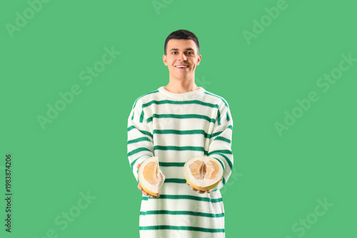 Young man with cut pomelo o...