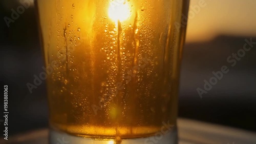 Refreshing Cold Beer Glass Close Up with Golden Sunset Background