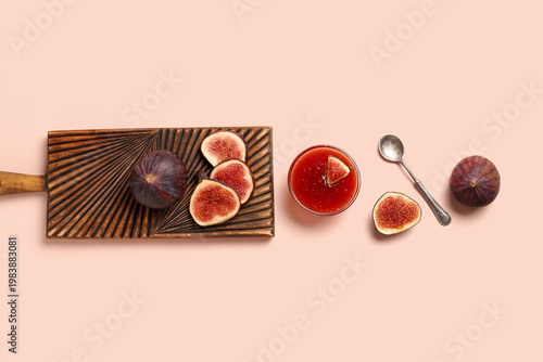 Photos Glass bowl of sweet fig jam and wooden board with fresh fruits on pink backgroun