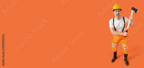 Firefighter holding axe on orange background with space for text
