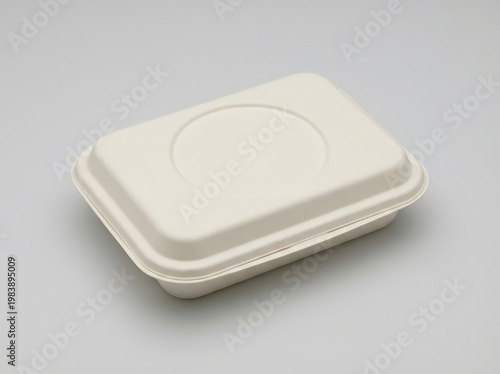 Closed beige takeout container on a light gray surface