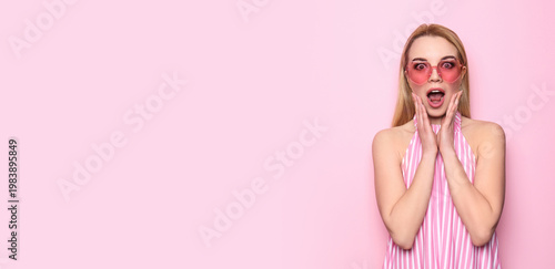 Obraz na plátně Surprised young woman on color background