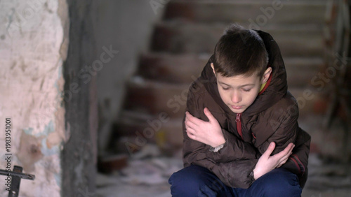 Konstfotografi boy freezing in warm clothing in a dilapidated old house, have fun and enjoy
