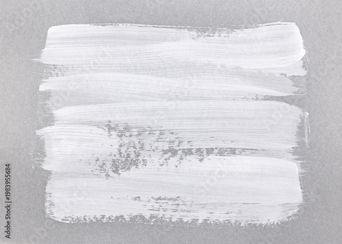 horizontal white brush strokes on textured gray paper background.