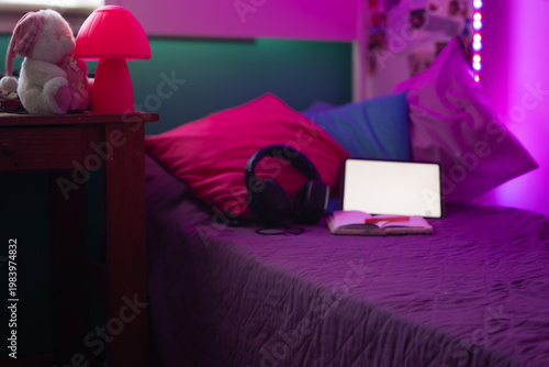 Bild auf Leinwand Teenager bedroom showing modern aesthetic with purple neon lighting, tablet, hea