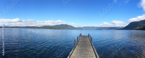 Slika na platnu Wooden jetty over blue lake water in Lake Te Anau - Peaceful scenic landscape of