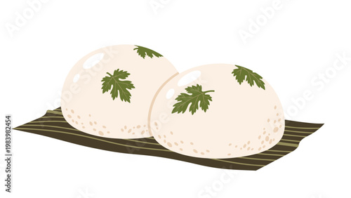 Two soft white round mochi cakes garnished with green leaves placed on a dark textured leaf or mat against a white background.