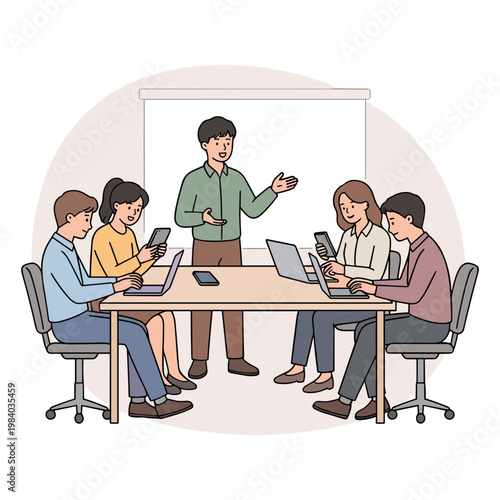 A man presents to colleagues sitting around a table with laptops.
