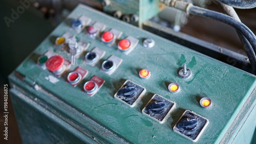 Photos Old industrial machinery control panel with buttons and switches