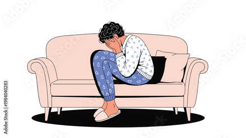 Sad person sitting on a sofa with their head in their hands experiencing deep sadness, stress, or depression symptoms.