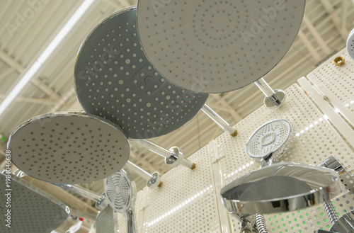 Display of various shower heads in a home improvement store during daytime shopping hours