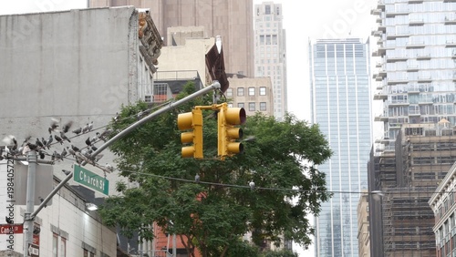 New York City Church street sign in Lower Manhattan, United States. Urban road sign and traffic light in american NYC. Building architecture, Tribeca district from Soho. Pigeon birds and Leonardo st.