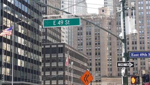 New York Park Avenue, 49 street sign in Manhattan Midtown, United States. Urban road sign in american city, traffic sign in NYC, USA. Building architecture near Grand Central. American flag.