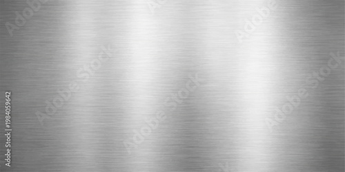 A polished silver stainless steel plate with a brushed metal texture creates a shiny industrial metallic background featuring a grey aluminum surface pattern on a sleek material sheet