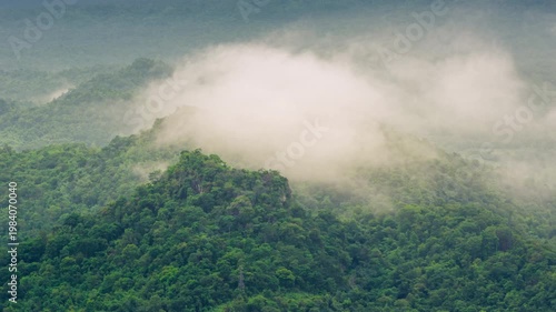 4k video of an aerial view of beautiful clouds or fog moving over the moutain peaks in northern Thailand.