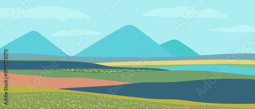 A flat landscape featuring rolling hills and distant mountains beneath a blue sky. A green meadow dotted with flowers and a picturesque mountain horizon—a background for travel-related themes.