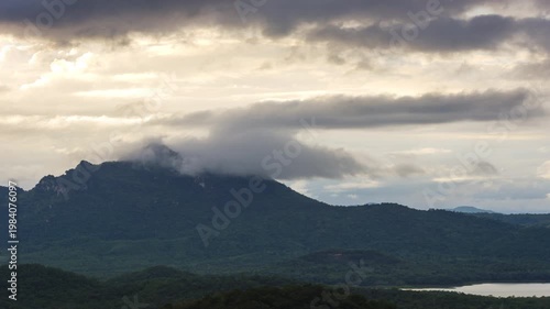 4K video of an aerial view of beautiful clouds or fog moving over the mountain peaks in northern THailand.