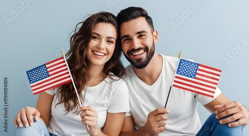 Happy independence day usa smiling couple celebrates with american flags patriotic fourth of july