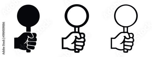 Foto Hand holding a paddle or round sign icon set in black and white.