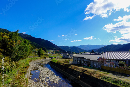 Mountain village along Shikoku Henro with riverbed and clear blue sky in rural Japan