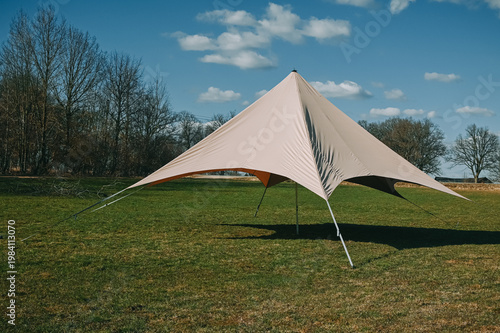 Stretch Tent Pavilion on Grass Field Under Blue Sky