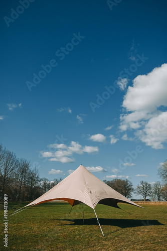 Outdoor Stretch Tent Canopy on Green Field Under Blue Sky