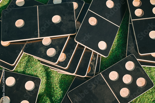 Stacked Wooden Domino Game Tiles on Grass Outdoor Setup