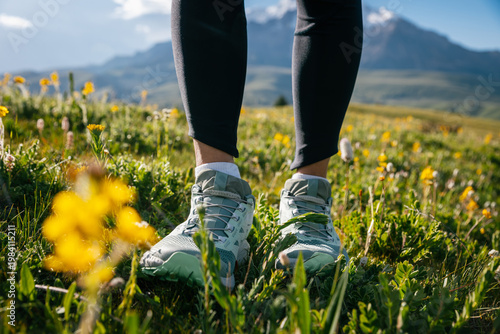 Trail runner  running  on the high altitude grassland mountain top