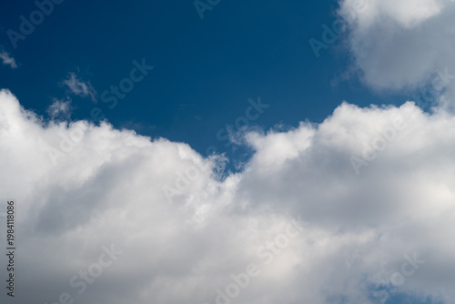 Fotografie Dramatic cloud bank against deep sky, heavy cumulus layers, brooding tones, appr