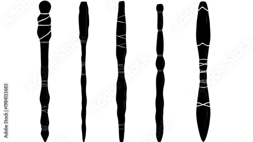 Black abstract shapes with white lines, arranged vertically, reminiscent of clubs or tools