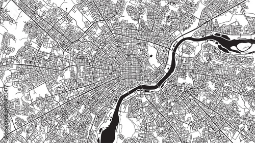 Aerial view of a cityscape with a winding river presented in high contrast black and white