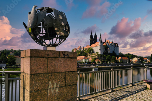 Panoramic view of Albrechtsburg Castle and Meissen Cathedral reflecting in Elbe river at dramatic sunset, Saxony, Germany