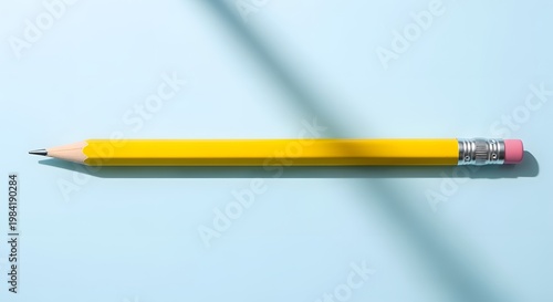 Yellow pencil with pink eraser on a light blue surface, sharp and ready.