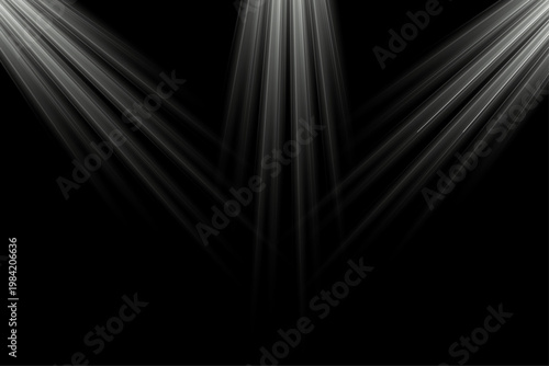Dramatic light effect beams of light shining down on a black background