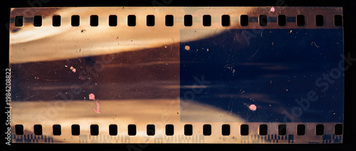 beginning of a 35mm film strip isolated on a black background, showing vintage analog texture, light leaks, scratches, and dust.