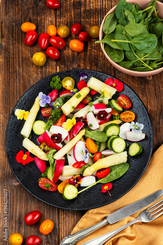Fresh Spring Salad with White Asparagus, Radish, Cherry Tomatoes and Edible Flowers