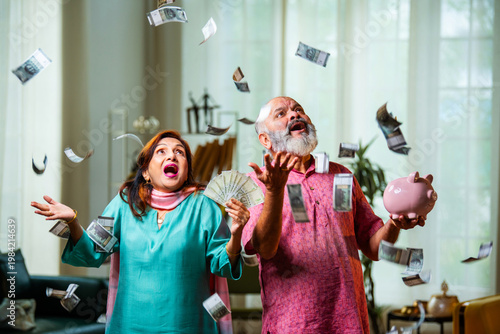 Εκτύπωση καμβά Retired Indian Couple Celebrating Sudden Savings Growth with Raining Money
