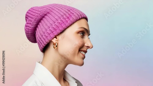 Young woman smiling with pink beanie against colorful background  