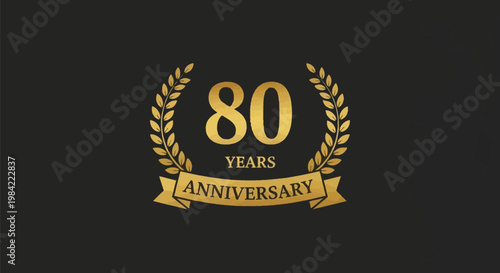 Golden 80th anniversary emblem featuring the number 80 surrounded by a laurel wreath and a banner with the text anniversary, set against a solid dark grey or black background.