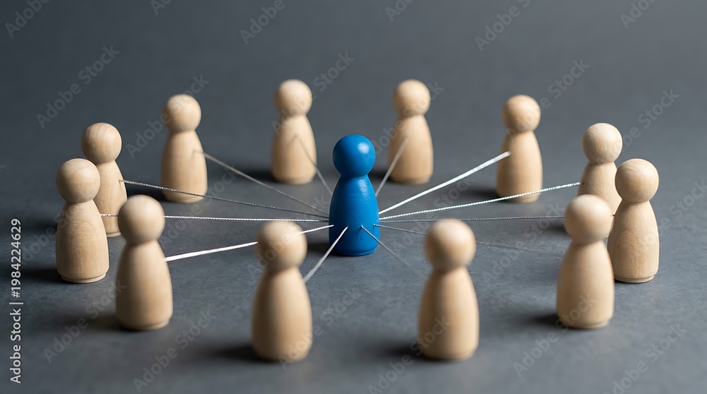 Obraz premium Connected team management concept represented by wooden figures with a central blue figure linked to others in a circle