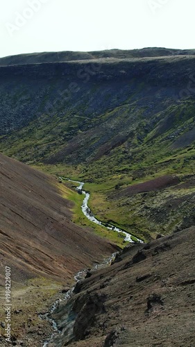 Iceland, river in a mountain valley, northern landscape from height, beautiful view of the Iceland nature and serenity view of the earth texture, river, nature background.