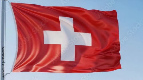Swiss flag waving in the wind against a blue sky  