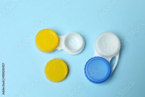 Case for contact lenses on blue background, top view