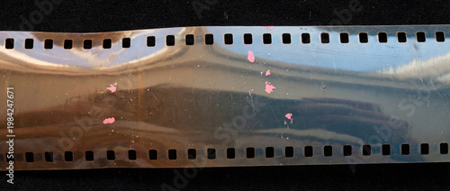 Damaged 35mm Film Strip with Light Leaks and Scratches on Black Background