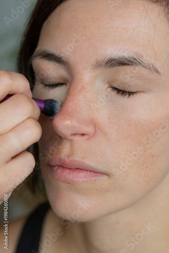 Wallpaper Mural Woman holding makeup pencil near eye. Concept of beauty application and personal care routine. Vertical photo Torontodigital.ca