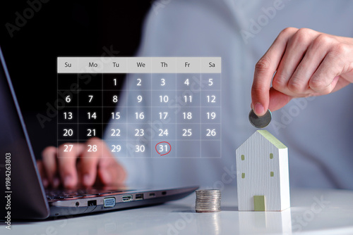 hand putting a coin into a small digital calendar interface showing a circled deadline date payment planning, monthly savings for a dream home, financial deadline management and property investment