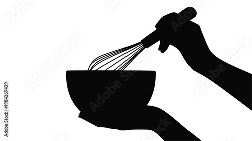 Silhouette of hands whisking ingredients in a bowl for cooking preparation