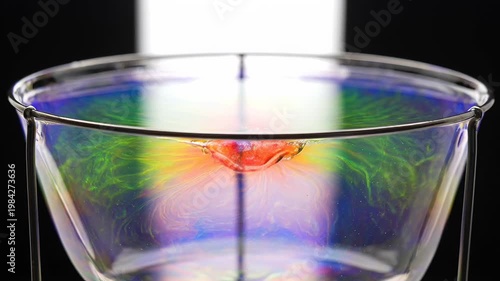 Colorful liquid swirl in glass basin